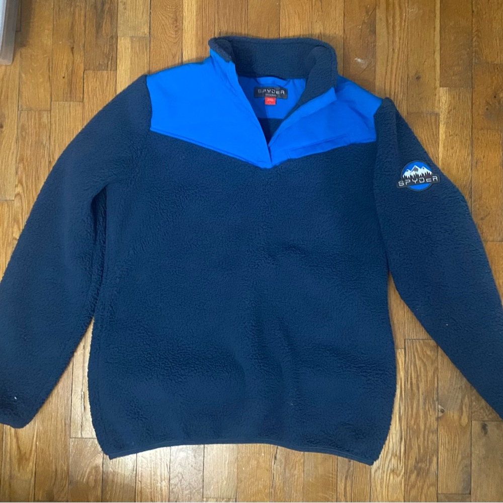 Woman’s blue Spider half zip pull over jacket